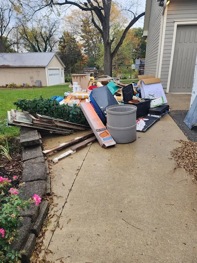 Dumpster being loaded with debris for Estate Cleanout Dumpster Rental in Garrett